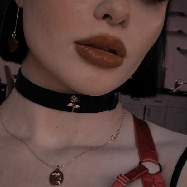 a close up of a person wearing a choker