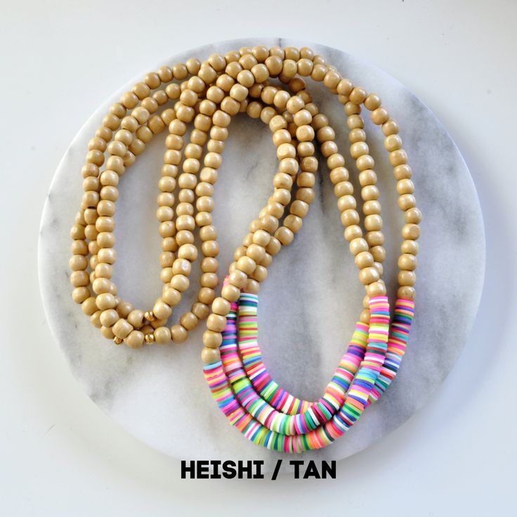 Get ready for summer with this wood beaded necklace! A mix of natural wood and bright heishi beads and in an easy pull-over-the-head style, these are sure to brighten up all your shorts-and-flip-flops looks. 8mm pale wooden beads + vinyl heishi beads in a random pattern gold-plated crimp with bead closure 28 inches long all Libby & Smee necklaces come packaged in a clear resealing bag for storage Summer Wooden Beaded Necklaces With Round Beads, Beach Wooden And Heishi Beads Necklaces, Summer Wooden Beaded Necklaces, Summer Wooden Beaded Round Necklaces, Adjustable Wooden Beads Necklace For Summer, Adjustable Beaded Necklace With Wooden And Heishi Beads, Wooden Beads For Summer Beach Occasions, Wooden Beads For Summer Beach, Summer Beach Wooden Beads