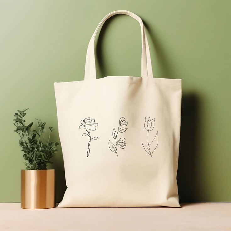 "Our tote bag is perfect for anyone who loves nature-inspired accessories. This floral line art tote bag is trendy and perfect for plant and flower enthusiasts. It is also a great gift for your loved ones who appreciate unique and chic fashion pieces. Whether you're a student, a working professional, or a fashion enthusiast, this tote bag is the perfect addition to your collection. ‣ Tap here to head back to the shop: https://www.etsy.com/shop/FukuDesignsUS ‣ Follow us on: IG - https://www.instagram.com/fukudesignsus/ Pinterest - https://www.pinterest.com/fukudesignsus/ ‣ Reach out to us for any questions that you have about our items. We are here to provide quality products and service to you. SHIPPING AND PRODUCTION TIME Returns are not accepted, but if you do have a concern, please reac Rectangular Bags With Plant Print For Daily Use, Everyday Rectangular Bag With Plant Print, White Botanical Tote Bag, Botanical White Tote Bag, White Botanical Rectangular Bag, Plant Print Tote Bag As Gift, Plant Print Tote Bag For Gift, Botanical Bags With Plant Print For Everyday Use, Botanical Bags With Plant Print And Rectangular Shape