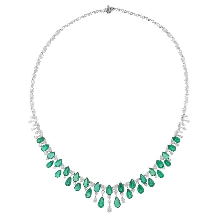 Immerse yourself in the enchanting allure of this Pear Zambian Emerald Gemstone Necklace, adorned with Pear and Round Diamonds, a breathtaking masterpiece of fine jewelry crafted in 18 Karat White Gold. Item Code :- SEN-51197 Gross Wt. :- 29.42 gm 18k White Gold Wt. :- 23.91 gm Natural Diamond Wt. :- 9.30 Ct. ( AVERAGE DIAMOND CLARITY SI1-SI2 & COLOR H-I ) Zambian Emerald Wt. :- 18.26 Ct. Necklace Length :- 16 Inches Long ✦ Sizing ..................... We can adjust most items to fit your sizing Luxury Diamond White Emerald Necklace, Luxury White Gold Gemstone Necklace, Luxury Exquisite Oval Emerald Necklace, Real Diamond Necklace, Art Deco Bracelet, Indian Necklace, Gemstone Necklaces, Zambian Emerald, Pear Shaped Diamond