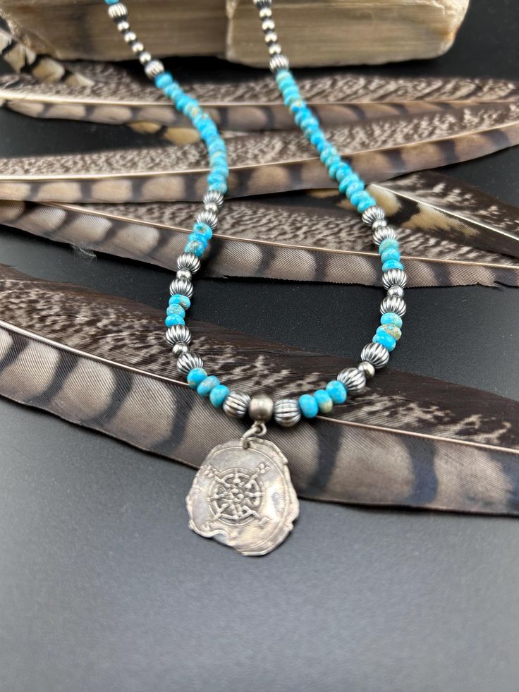 This is a gorgeous sterling silver Navajo Pearl necklace with a variety of Kingman turquoise rondelle beads.  The Navajo pearls range from 4mm to 6mm, with the corrugated being 6mm.  This has a handmade sterling silver compass 3/4 inch in size.  The necklace is 19 inches from end to end, it attaches with a sterling silver hook clasp.   Beautiful piece that goes with anything anywhere. Artisan Sterling Silver Jewelry With Spacer Beads, Artisan Jewelry With Spacer Beads In Sterling Silver, Bohemian Beaded Necklace With Sterling Silver Clasp, Bohemian Silver Turquoise Necklace With Spacer Beads, Silver Turquoise Necklace With Round Beads In Southwestern Style, Southwestern Silver Turquoise Necklace With Gemstone Beads, Southwestern Sterling Silver Beaded Necklaces, Hand-strung Turquoise Necklace With Sterling Silver Round Beads, Artisan Sterling Silver Turquoise Necklace With Polished Beads