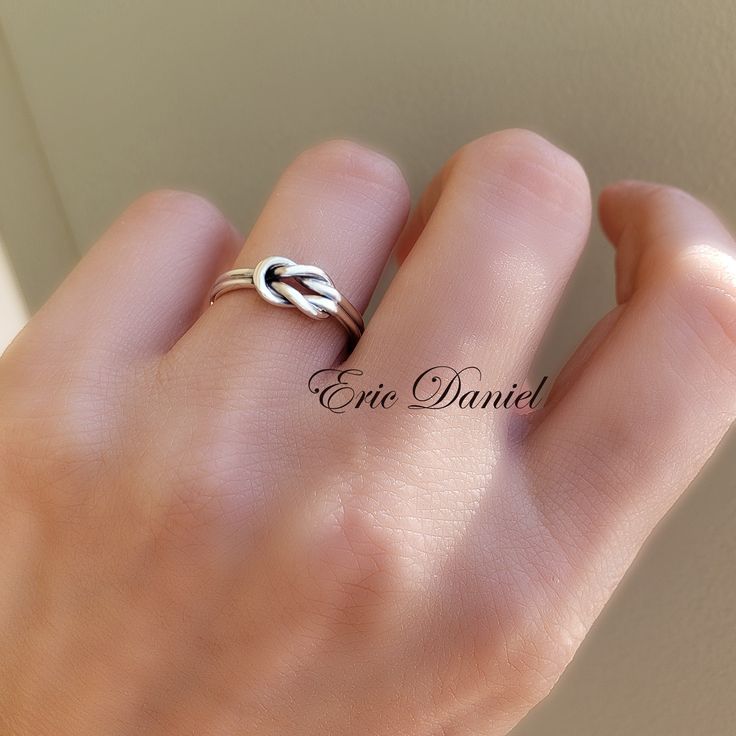 This simple yet timeless love knot ring is made of genuine .925 Sterling Silver. There is a slight bend on one side of the ring which is necessary for the one knot to loop under the other. This is normal and not a defect of the ring. Metal: Sterling Silver Sterling Silver with Yellow Gold Overlay Sterling Silver with Rose Gold Overlay Production Time: Silver: 3-5 Business Days Silver with Yellow or Rose Gold: 7-10 Business Days Customer Service is our top priority. If you are unhappy with your p Adjustable Infinity Stackable Anniversary Rings, Modern Twist Infinity Stackable Rings As Gift, Adjustable Infinity Stackable Rings For Anniversary, Adjustable Infinity Promise Ring, Elegant Hypoallergenic Stackable Rings For Promise, Dainty Infinity Stackable Promise Rings, Adjustable Infinity Stackable Rings Gift, Sterling Silver Infinity Stackable Rings As Gift, Gift Sterling Silver Infinity Stackable Rings