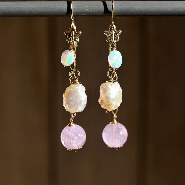 Experience the elegance and whimsy of our Butterfly Pink Dangle Earrings. Featuring soft, natural gemstones in stunning shades of pink and a luxurious 14K gold fill, these earrings make a bold statement. With a length of 2 1/2 inches, they effortlessly capture attention while also exuding a playful charm. A must-have staple for any wardrobe! Gemstones: 🔸Opals 🔹Morganite Rounds 🔸Pink Freshwater Pearls Metals: ♦️14K Gold Fill ♦️14K Gold Filled Butterfly Length: ♦️2 1/2” Handmade Pink 14k Gold Jewelry, Dainty 14k Gold-filled Earrings With Natural Stones, Handmade 14k Gold Pink Jewelry, Pink Briolette Earrings With Natural Stones, Pink 14k Gold-filled Wire Wrapped Earrings, Pink 14k Gold Filled Dangle Jewelry, Pink 14k Gold-filled Dangle Jewelry, Pink Briolette Natural Stone Earrings, Elegant Gold Jewelry With Pink Opal