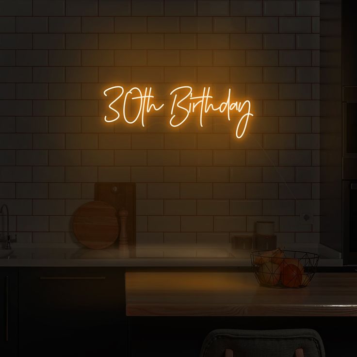 a neon sign that reads 30th birthday on the wall above a kitchen counter with an oven