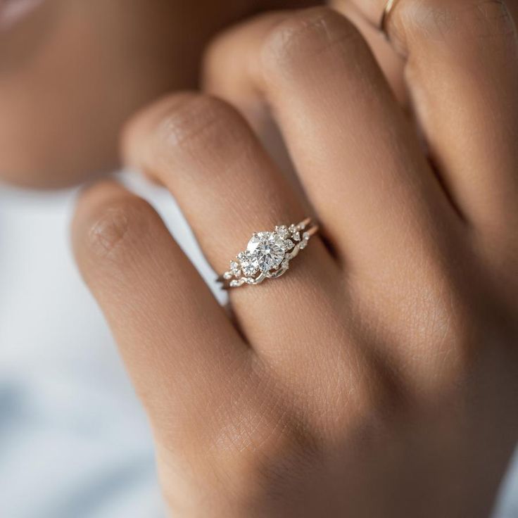 a woman's hand with a diamond ring on it