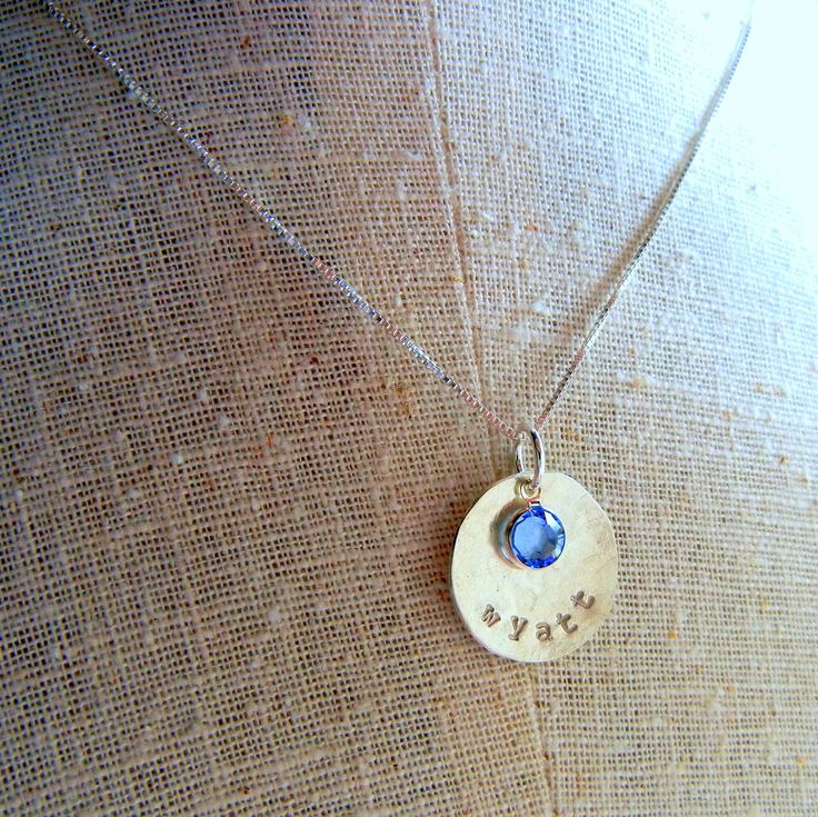 "This birthstone necklace features a name charm, personalized from all .925 sterling silver. This custom jewelry is designed and crafted by E. Ria Designs. TO PERSONALIZE: Please choose chain length and crystal at checkout. See last photo for font options. Leave a note about your font choice in the message box at checkout. The pendant measures 3/4\" before hammering/cupping. Select your chain and crystal birthstone at checkout. The crystal is a genuine Swarovski crystal. Need an additional penda Dainty Sterling Silver Name Necklace With Birthstone, Silver Name Charm Necklace For Everyday, Personalized Birthstone Pendant Necklace For Everyday, Silver Dainty Name Necklace With Birthstone, Personalized Dainty Sterling Silver Birthstone Necklace, Dainty Personalized Sterling Silver Birthstone Necklace, Everyday Sterling Silver Charm Necklaces With Birthstone, Everyday Sterling Silver Birthstone Charm Necklaces, Silver Personalized Custom Necklace For Everyday