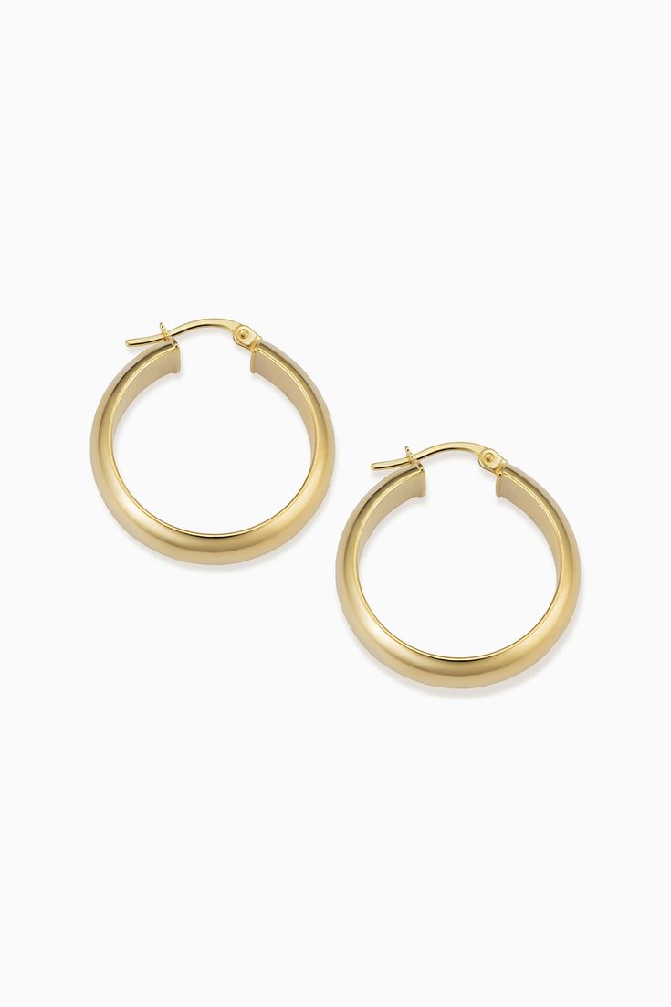 Radiant. Bold. Timeless. Our High Society Large Hoops are the statement earrings every fine jewelry collection needs. The wide, flattened solid gold tubes give them a classic, vintage feel, while the curved design creates a dome effect for maximum shine. Metal: 14 Karat Yellow Gold Dimensions: 6mm Width, 20mm Inner Diameter Construction: Solid Gold Tubing, Latch Closure Weight: 3 Grams Origin: Crafted in Arezzo, Italy Classic Gold-tone Huggie Jewelry, Classic Gold-tone Gold-plated Hoop Earrings, Classic Gold-tone Tarnish Resistant Hoop Earrings, Classic Polished Finish Earrings For Anniversary, Classic Yellow Gold Plated Earrings, Classic Polished Earrings For Anniversary, Classic Polished Yellow Gold Earrings, Classic Yellow Gold Polished Earrings, Classic Polished Finish Yellow Gold Earrings