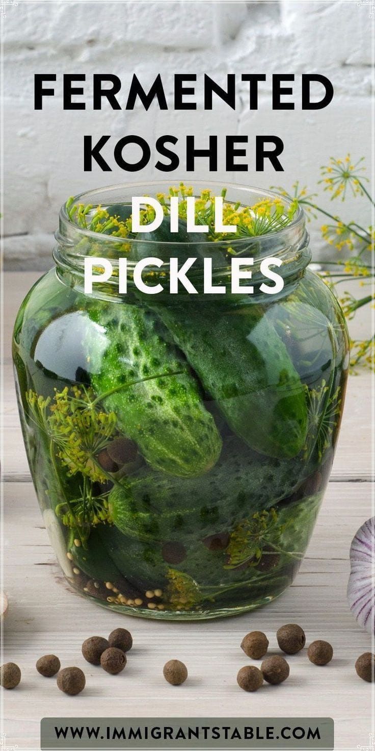 a jar filled with pickles sitting on top of a table