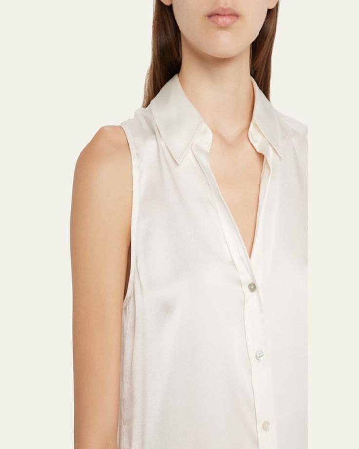 L'Agence "Emmy" lustrous blouse finished with tonal buttons     Spread collar; button front    Sleeveless    Yoked back    Relaxed fit    Shirttail hem    Silk    Dry clean    Imported Sleeveless Workwear Top With Back Button Closure, Sleeveless Tops For Work With Back Button Closure, Elegant Sleeveless Button Blouse, Elegant Sleeveless Top With Back Button Closure, Chic Sleeveless Top With Back Button Closure, Elegant Sleeveless Blouse For Daywear, Elegant Summer Top With Button Back, Elegant Button Back Summer Tops, Elegant Summer Tops With Button Back