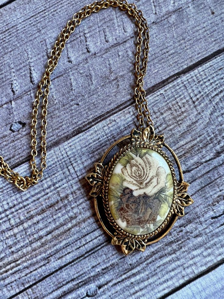 Vintage pendant features a gold tone chain and mounting of a cameo of two roses. Back of the pendant says Coventry. Size: Pendant is 2 inches by 1.5 inches  Chain is 24 inches long.  This lovely vintage piece would make an adorable gift.  Thanks for looking! Vintage Jewelry With Rose Design Flower Pendant, Vintage Rose Design Pendant Jewelry, Vintage Rose Design Necklace For Gift, Vintage Rose Design Flower Pendant Jewelry, Victorian Gold Jewelry With Rose Design, Antique Gold Jewelry With Rose Design, Vintage Rose Design Flower Pendant Necklace, Two Roses, Vintage Cameo