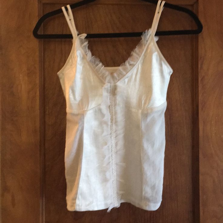 Beautiful Buffalo Naya Tank Top In Ivory. Size Medium 95% Polyester 5%Spandex Mesh This Beautiful Satin Tank Top Has Mesh Sides And The Collar And Front Is Adorned With A Light Embellished Feature. Resembles A Corset. Straps Are Elastic And Adjustable. Very On Trend And Stylish. Fitted V-neck Tank Top For Daywear, Fitted White Tank Top With Built-in Bra, Fitted Cream Camisole With Built-in Bra, Feminine White Top With Built-in Bra, Fitted Cream Tank Top With Built-in Bra, White Fitted Cami Tank Top, Fitted White Cami Tank Top, White Fitted Camisole For Daywear, Fitted White Camisole For Daywear