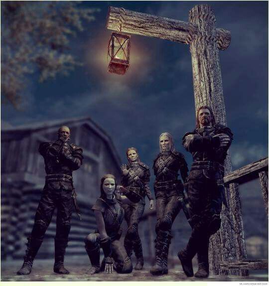 a group of people standing in front of a cross with a lantern hanging from it