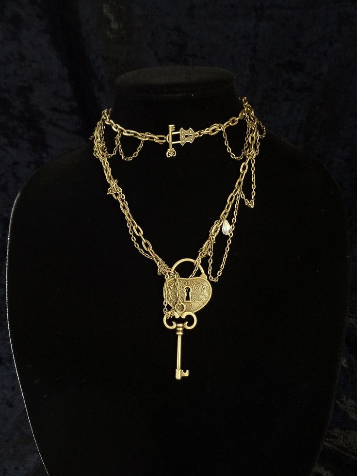 "This beautiful asymmetric necklace is artsy and romantic, but at the same time it's pretty bold and versatile. You can wear it long or wrap it around your neck twice which will place the decorative lock and key toggle clasp on the front and turn your Boho necklace into a Victorian choker. If you want to wear the necklace as a choker please, make sure you select sufficient length before checkout. The necklace you see in all the photos is 31\" (78.8 cm) long. 1\" = 2.54 cm. The key charm is remov Elegant Heart-shaped Necklace With Two Keys, Vintage Gold Jewelry With Keys, Gold Heart Necklace With Two Keys, Vintage Gold Necklaces With Keys, Vintage Gold Key Necklace, Gold Brass Necklace With Keys, Heart Lock And Key, Victorian Choker, Key Charm Necklace