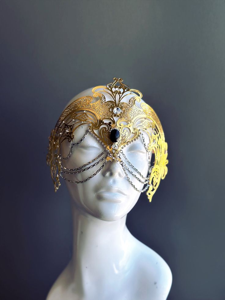 Step into the realm of goddesses with our women's masquerade mask in gold. Rhinestones delicately embellish the mask, adding a touch of sparkle. Silver chains gracefully adorn the mask, creating an enchanting movement. Capture attention at any masquerade party, ball, or themed event!


Age Group/Gender - Adult/Women

Size/Type - One size fits all adults

Mask Color - Gold

Mask Material - Laser Cut Metal

Special Features - Chains and rhinestones