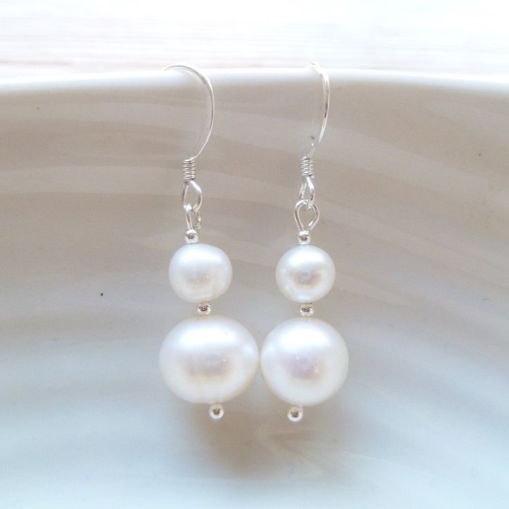 Double pearl drop dangle earrings serve as a dainty and elegant accent without overpowering the rest of your outfit making them ideal as part of a bridal outfit or for the bridesmaids at your wedding.  The moment you choose to wear dainty pearl drop earrings, either basic or statement-like, it's best to tie up your hair in a bun or a more sophisticated updo to let the earrings stand out and enhance your facial features.  FEATURES: * real cultured freshwater pearls * ivory white with beautiful lustre * .925 sterling silver ear hooks  * nickel-free * entirely handmade in the UK * free first class shipping within UK  You may also like these pearl stud earrings here: https://www.etsy.com/listing/769109465/ Elegant Nickel-free Linear Earrings For Wedding, Elegant Wedding Linear Earrings, Nickel-free Teardrop Dangle Earrings For Wedding, Nickel-free Dangle Teardrop Earrings For Wedding, Nickel-free Dangle Earrings For Bridesmaids, Dangle Earrings For Bridesmaid Gift, Nickel Free Dangle Earrings For Bridesmaids, Pearl White Nickel Free Drop Earrings, Nickel-free Pearl White Drop Earrings