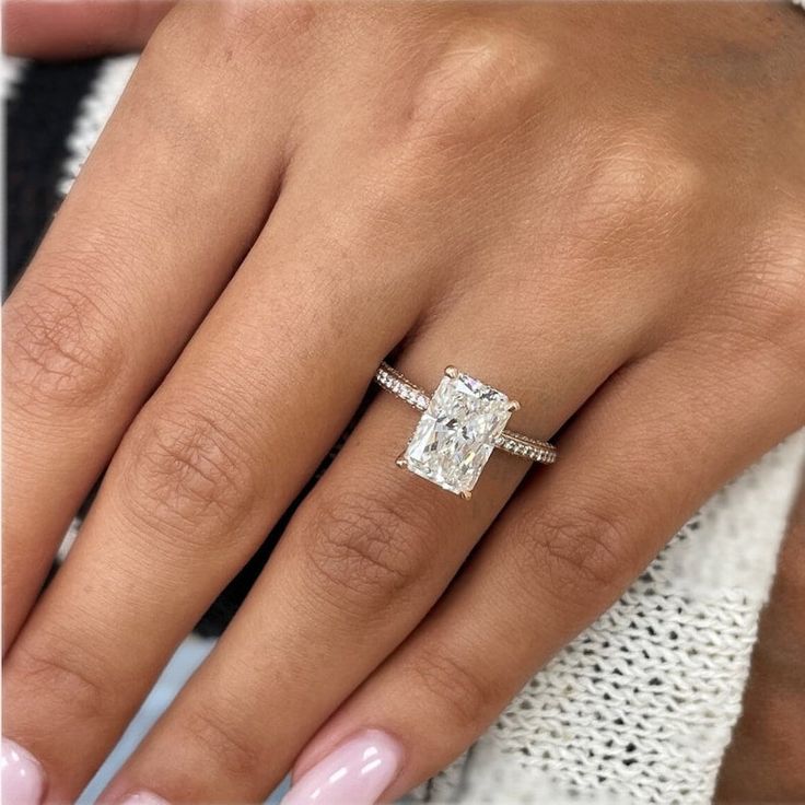 a woman's hand with a diamond ring on it