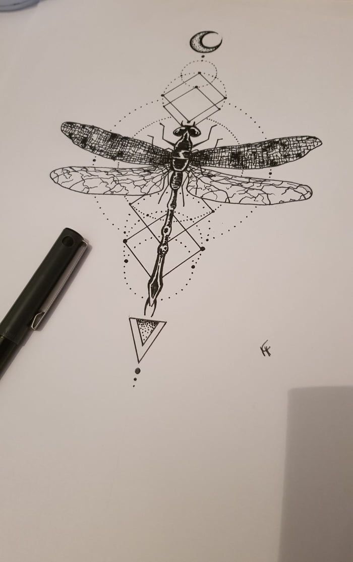 a drawing of a dragonfly sitting on top of a piece of paper next to a pen