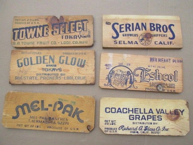 four wooden labels are hanging on the wall