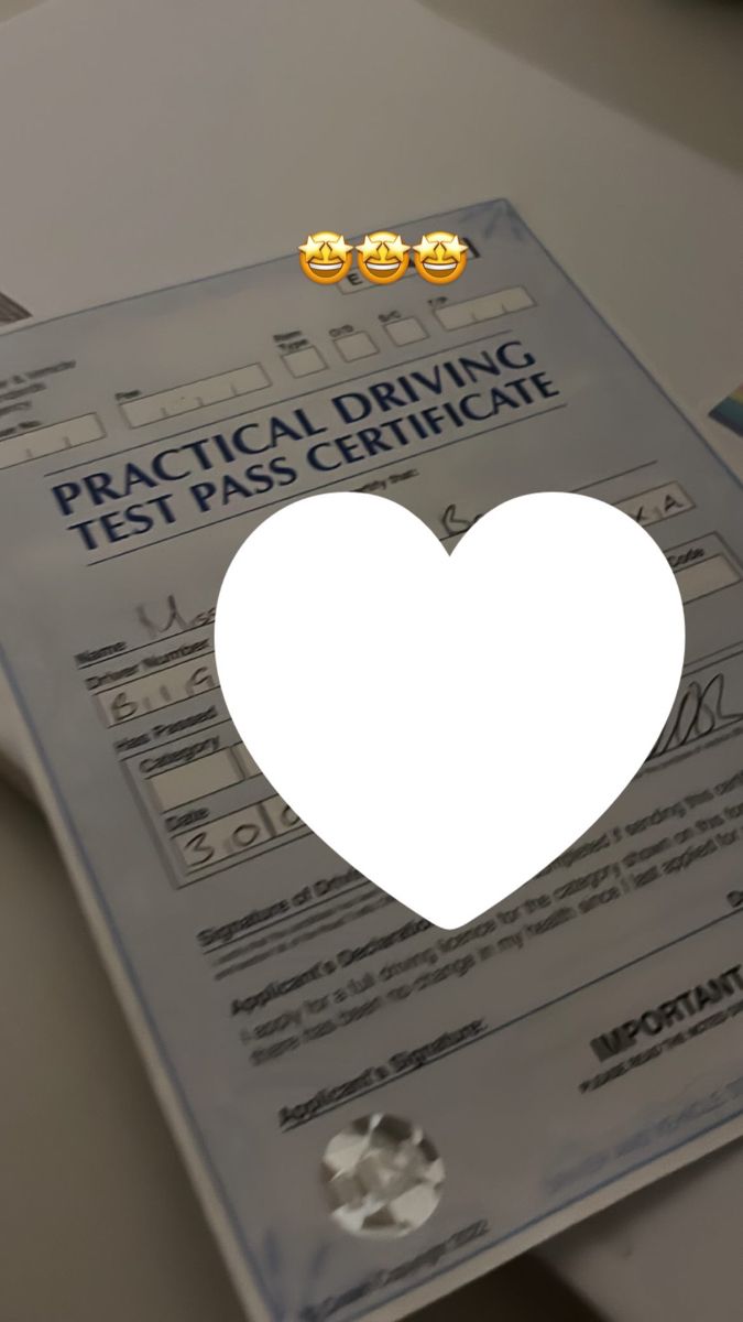 a heart shaped paper cut out on top of a piece of paper with the words practical driving test pass certificate