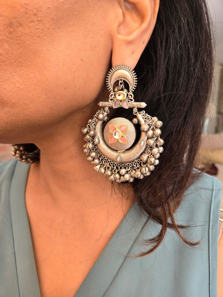 Statement silver boho ghungroo Kundan chandbaali earrings for a stunning look. Perfect for adding a unique and stylish touch to any outfit. Earring Dimensions:  Approximately 3.2 Inches Long  Approximately 2 Inches Wide  A Earring Weight is 1.3 oz All our products are crafted using traditional skills from our rich heritage. The manual nature of these crafts means that irregularities or variations are inherent in the handcrafting process. Bohemian Metal Chandbalis Drop Earrings, Silver Kundan Chandelier Earrings With Intricate Design, Silver Chandbali Fusion Jewelry, Silver Temple Jewelry Chandelier Earrings With Latkans, Bohemian Round Chandbalis, Bohemian Bridal Earrings With Intricate Design, Metal Chandbali Bridal Earrings, Festival Chandbali Hoop Earrings With Latkans, Bohemian Chandbali Hoop Earrings With Latkans