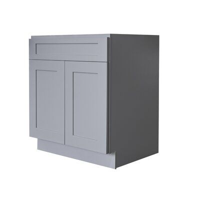 a gray cabinet with two doors and one drawer on the left side, against a white background