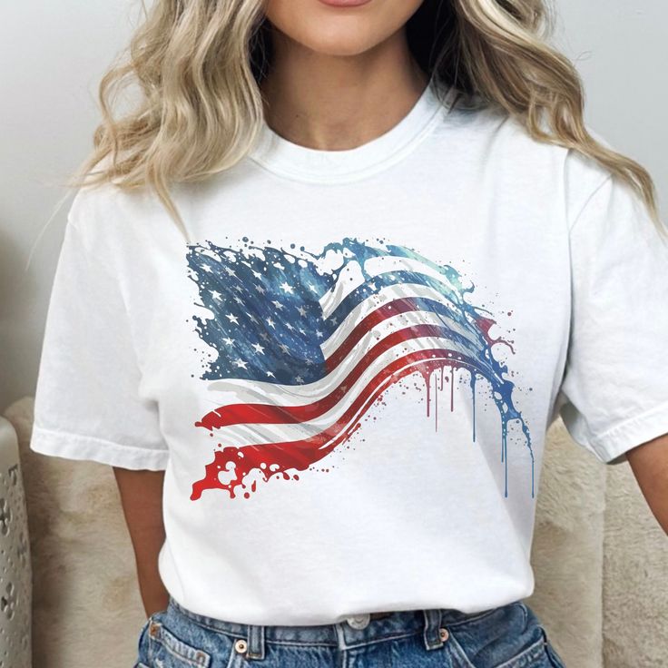 "Celebrate Independence Day with our collection of Fourth of July shirts, including our USA Flag designs. Our Unisex T-shirts make the perfect gift for all and are a must-have for any party in America. Show off your patriotic spirit with our USA T-shirt and America shirt, perfect for Flag Day and all summer long.  See my shop for other options.  Copy link below. https://www.etsy.com/shop/StaySmartDesign?ref=seller-platform-mcnav *Comfort color garment dyed shirts are super popular right now and these cotton washed tees are the nicest, softest shirts to wear. The colors are true, amazing and gorgeous and will never pile. The double-needle stitching throughout the tee makes it highly durable while the lack of side-seams helps the shirt retain its tubular shape.  Shirts look retro and vintage White American Flag T-shirt For Independence Day, White T-shirt With American Flag For Independence Day, White Americana T-shirt With American Flag, White American Style Tops For Memorial Day, Patriotic Tops With Flag Print For Veterans Day, Patriotic Flag Print Top For Veterans Day, White Americana T-shirt With American Flag Print, White Graphic Tee With American Flag, White T-shirt With American Flag