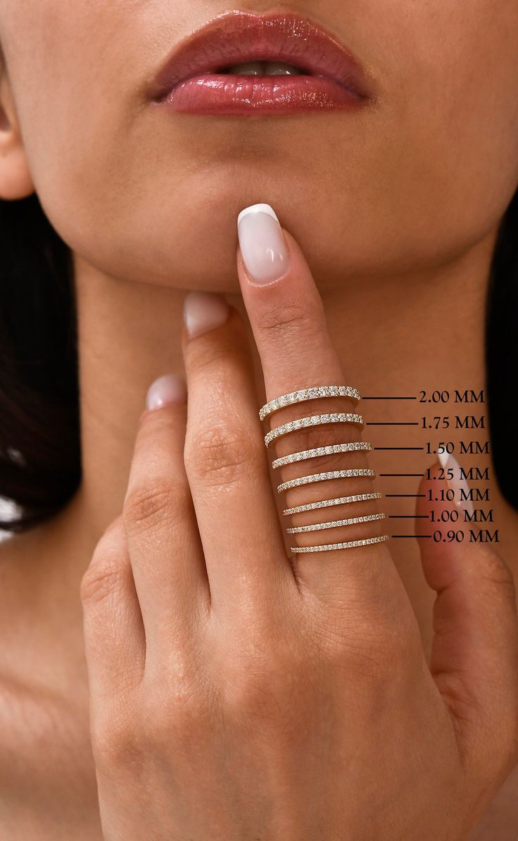 a woman holding her finger up to her right hand with the measurements on it and an arrow