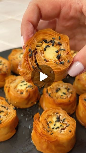 a person is sprinkling some kind of pastry with black seeds on top of it