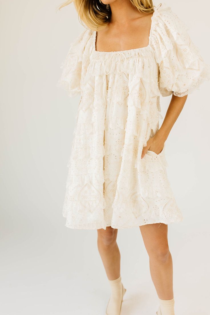 have your main character moment with this dreamy ivory puff sleeve mini dress. featuring dainty lace trim details + an elegant square neckline, this dress has heirloom-quality energy. from bridal showers to dinner dates, it’s guaranteed to be your new go-to. off white // mini length, scoop neckline, elastic neckline, lined, front bow detail, pockets, elastic cuffs model is 5'8" + wearing a small measurements are approximate + taken while laying flat xsmall : bust 32” length 31.5” small : bust 34 Cream Mini Dress With Ruffles And Square Neck, Feminine Puff Sleeve Dress With Lace Trim For Brunch, Puff Sleeve Mini Dress With Lace Trim For Brunch, Cream Mini Dress With Lace Trim For Garden Party, Puff Sleeve Dress With Lace Trim For Garden Party, Cream Lace Trim Mini Dress For Garden Party, Lace Puff Sleeve Dress For Brunch, Puff Sleeve Mini Dress With Lace Trim, Cream Puff Sleeve Mini Dress