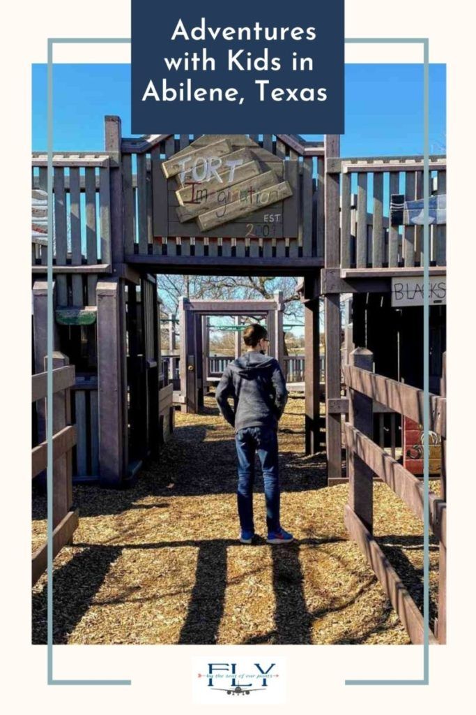 a person standing in front of a wooden structure with the words adventures with kids in abilene, texas