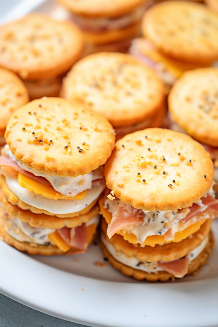 crackers and sandwiches are arranged on a plate