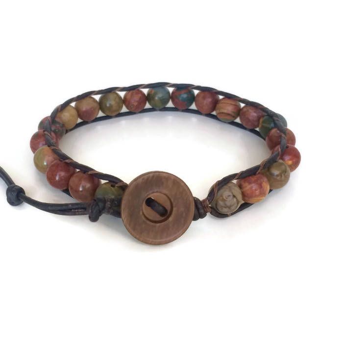 This gemstone bracelet for men is made with 8mm Picasso Jasper Beads individual woven onto natural dark brown leather cord. This men's gemstone bracelet would make a great addition to your wardrobe. The deep colors of greens, browns and burgundy run throughout the beads. Each bracelet is made with top quality leather and gemstone beads. To choose the proper length, simply measure your wrist and add as much length as you want for a comfortable fit. Adjustable Leather Bracelets With Natural Stones, Brown Braided Bracelets With 8mm Beads, Adjustable Brown Leather Bracelet With Natural Stones, Adjustable Brown Beaded Bracelet With Gemstone Beads, Adjustable Brown Gemstone Beaded Bracelets, Adjustable Hand Wrapped Leather Bracelet With Round Beads, Brown Braided Bracelets With Hand-strung Round Beads, Brown Hand-strung Braided Bracelets With Round Beads, Adjustable Spiritual Leather Bracelet With Natural Stones