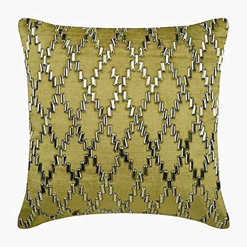 a gold pillow with silver and black designs on it