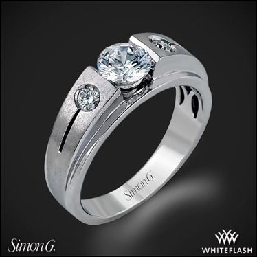 a white gold ring with two diamonds on the side and an inscription that says,