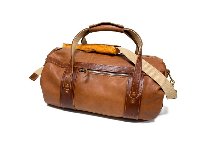 Natural Leather with Chestnut Leather Trim Club Duffel Bag- Steurer & Jacoby Travel Bags In Bridle Leather With Waxed Finish, Travel Bag With Waxed Finish And Bridle Leather, Classic Leather Satchel For Weekend Trips, Dark Tan Travel Shoulder Bag, Rugged Brown Duffle Bag With Leather Handles, Travel Satchel With Waxed Vegetable Tanned Leather, Leather Shoulder Bag With Leather Lining For Weekend Trips, Brown Bridle Leather Bags With Leather Handles, Rugged Travel Bag With Leather Patch