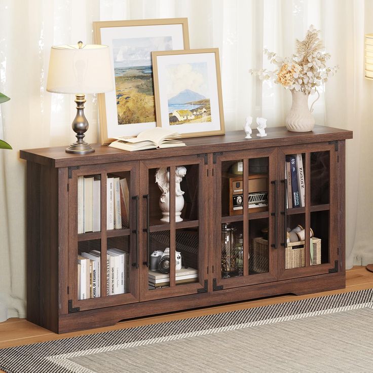 a living room with a book shelf and pictures on the wall next to a rug