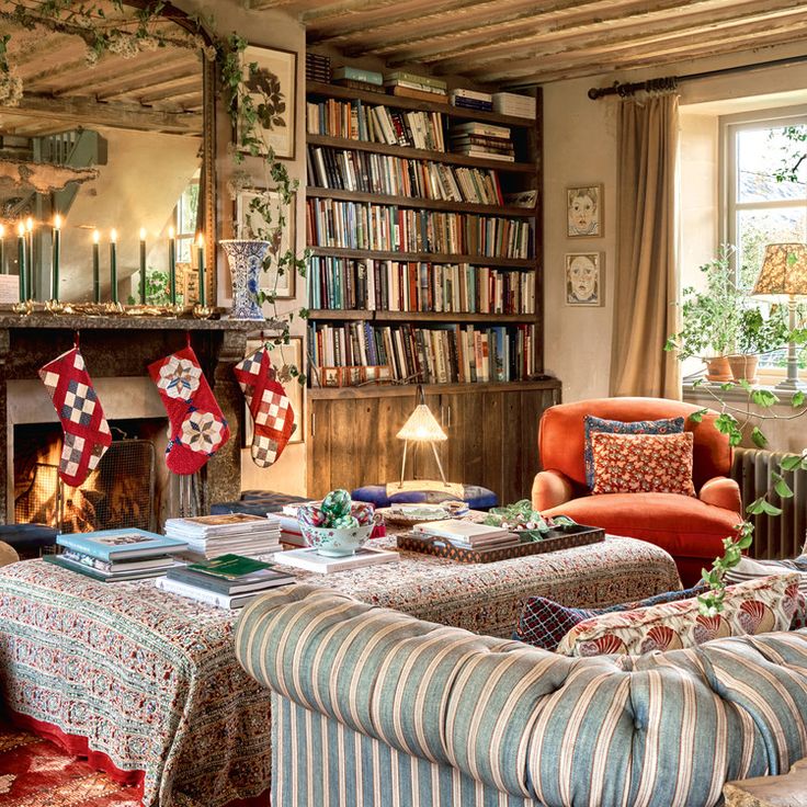 a living room filled with furniture and a fire place in front of a book shelf