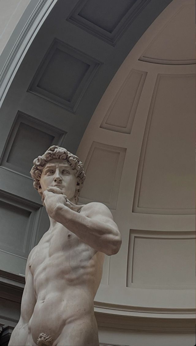 a statue of a man standing in front of a building