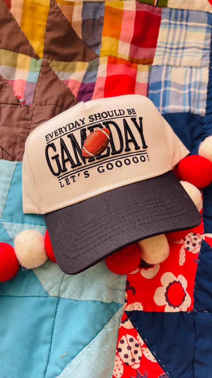 Score a touchdown with the Everyday Should Be Game Day Football Trucker Hat! This trucker hat features a playful embroidered saying and a football, perfect for game day. With its adjustable fit, black brim, and cream body, this hat is the perfect accessory for any game day outfit. Don't wait for game day, make everyday a game day with this cute and quirky hat! *All Sales Final on Accessories. Baseball Cap For Tailgating During Baseball Season, Retro Letter Print Baseball Cap For Baseball Season, Sporty Curved Bill Hat For Game Day, Sporty Dad Hat With Curved Bill For Game Day, Sporty Curved Bill Dad Hat For Game Day, Sporty Snapback Hat For Game Day, Team-colored Trucker Hat With Letter Print For Game Day, Game Day Team-colored Trucker Hat With Letter Print, Retro Cap For Game Day