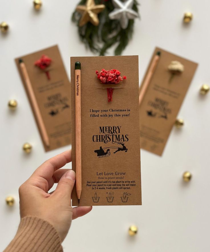 a person holding up a christmas card with candy on it