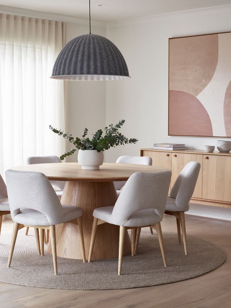 a dining room table with four chairs around it