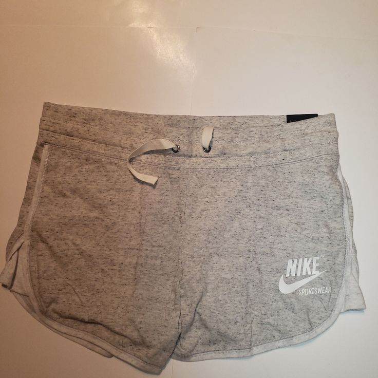 Nike Women's Sportswear Slim Fit Shorts Medium Slim Fit Shorts Elastic Waistband With Drawcord For Custom Fit Open Hand Side Pockets Nike Logo Graphic At Hemline Color: Grey Cotton Joggers For Workout During Sports Season, Nike Cotton Activewear With Built-in Shorts, Sporty Activewear With Drawstring For Leisure, Comfortable Nike Bottoms With Built-in Shorts, Casual White Activewear With Comfort Waistband, Nike Sporty Joggers For Leisure, Sporty Nike Joggers For Leisure, Comfortable White Sports Joggers, Comfortable White Joggers For Sports