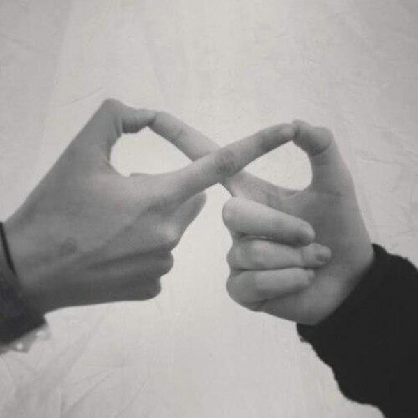 two hands making the shape of a heart with one hand and another holding the other