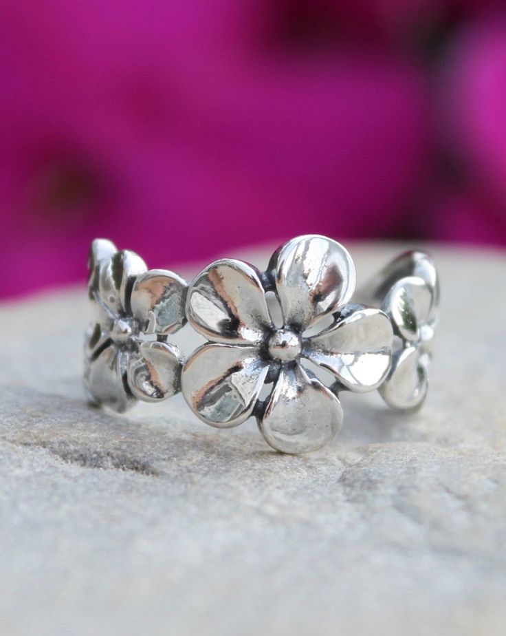 Sterling Silver Plumeria Flower Ring | The Life Divine Flower detail measures approximately 1/2" H Spring Flower Jewelry For Anniversary, Flower Shaped Birthstone Promise Ring, Adjustable Flower Ring For Spring Anniversary, Spring Anniversary Adjustable Flower Ring, Silver Flower Shaped Rings For Spring, Flower Shaped Birthstone Ring, Spring Flower Promise Ring, Adjustable Flower Stackable Rings For Promise, Adjustable Flower Stackable Promise Rings