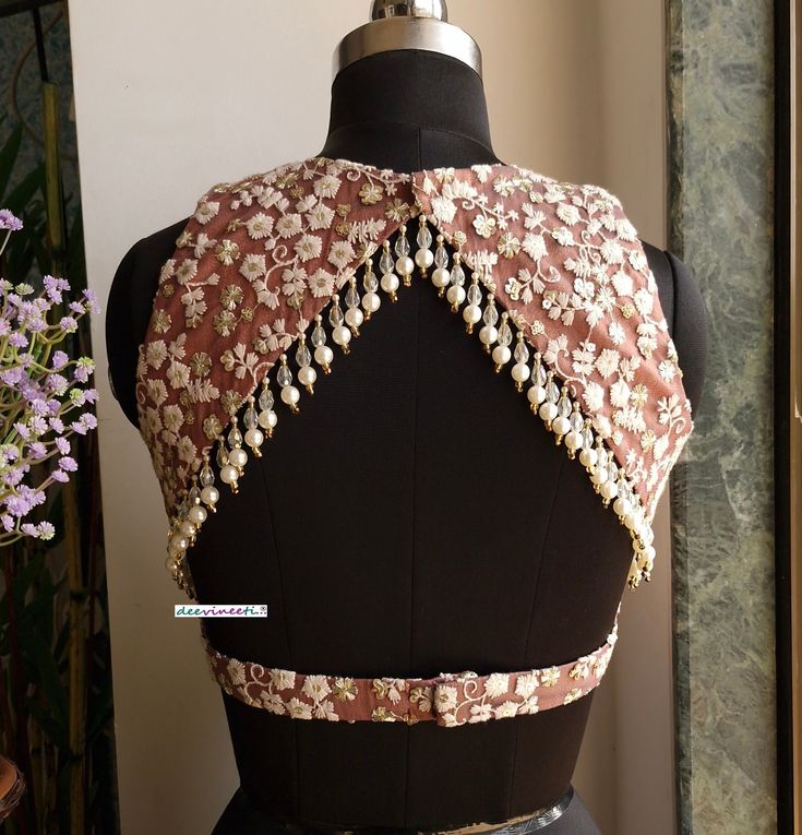 This Made to Order/Made to Measurement/Custom Made Indian Ethnic Blouse. - Fabric - Embroidered Net - Color - Mauve Brown with off-white embroidery - Padded - Princess Cut - Jewel Neck - Lined - Back Hook Closure - Backless with beads embellishment - Extra margin and extra stitches included in the blouse PLEASE NOTE: BUYERS ARE RESPONSIBLE FOR ANY CUSTOMS AND IMPORT TAXES THAT MAY APPLY. This is a made to order product. If you opt for 'Made To Measurement Option', we will provide a measurement template and you can share the measurements likewise. If you want to opt for 'Standard Size', Please refer to the size chart provided in the listing. Shipping: Standard Shipping is done by DHL ecommerce and it mostly takes 2 to 3 weeks to deliver after dispatch. Express Shipping is done by DHL expres Blouse Patterns Front And Back, Designer Back Neck For Blouse, Back Neck Designs For Lehenga Blouses, Heavy Blouse Back Design, Front Net Blouse Design, Blouse Designs Georgette Saree, Both Neck Blouse Design, Padded Blouse Designs Back, Backless Blouse Designs For Saree