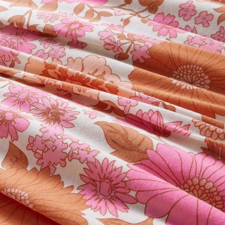 an orange and pink floral print fabric