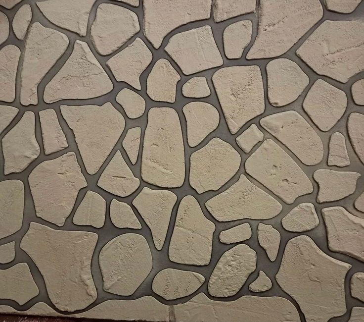 a close up of a stone wall that looks like it is made out of cement