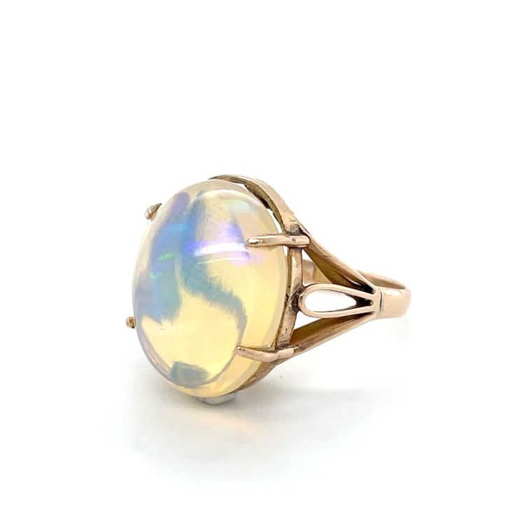 "Flashes of color play from this stunning 9.54 carat opal cabochon set in a lovely 14K yellow gold ring with swirling metal details.  Marked \"14K\".  A wonderful addition to your personal jewelry collection. FREE SHIPPING! Details:  14K Yellow Gold: (shown in picture) Natural Opal: (1) 17.6 mm x 14.2 mm oval cabochon Approximate Gem Weight: 9.54 Carat Gem Color: Yellow with multi-color flashes Ring Size: 6 3/4 Total Weight: 4.9 grams FREE Domestic Shipping by USPS Priority Mail Delivery Confirmation and includes insurance. If the item is to be shipped internationally Etsy will calculate postage. Please notify us at time of purchase if you are buying more than one item and we will gladly combine shipping. 7 day \"no hassle\" return policy money back guarantee. If for any reason you are not Flash Ring, Jewellers Bench, Personal Jewelry, Color Play, Mail Delivery, Yellow Gold Ring, Natural Opal, Oval Cabochon, Ring Ring