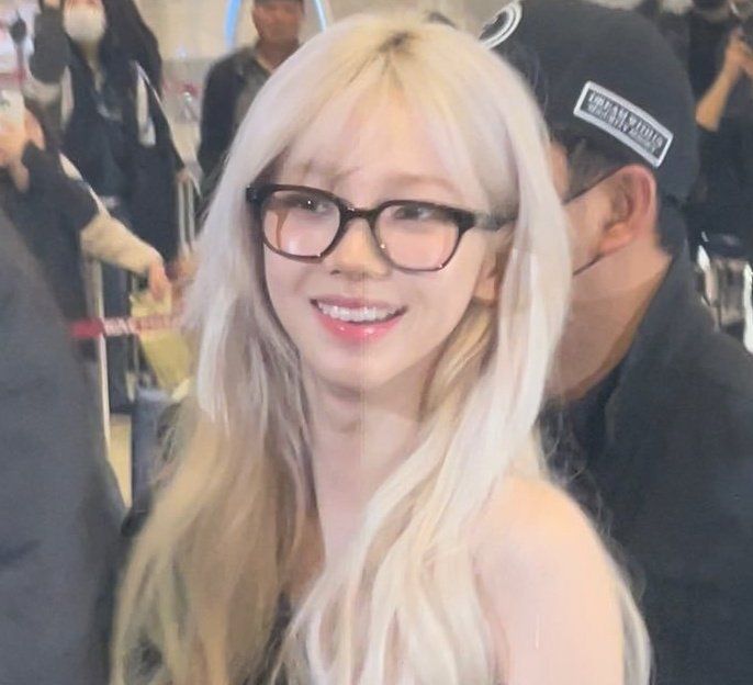 a woman with long blonde hair wearing glasses