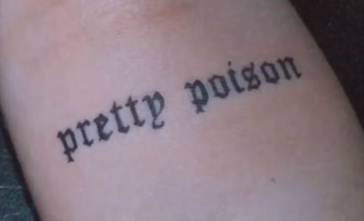 a tattoo that reads pretty prison on the side of someone's leg and is written in black ink